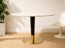 Load image into Gallery viewer, Vintage oval marble-top dining table with sleek black center pedestal and brass disc base.