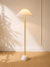 Load image into Gallery viewer, Modern brass floor lamp with pleated white shade and sculptural white marble dome base.