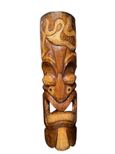 Load image into Gallery viewer, A carved wooden tiki mask sculpture with detailed facial features and swirling patterns, displayed against a dark textured background.