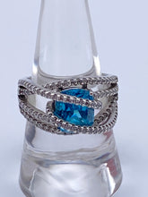 Load image into Gallery viewer, Sterling Silver Blue Topaz Bypass Ring with Cubic Zirconia Accents