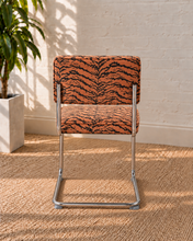 Load image into Gallery viewer, Modern 70s-style dining chair with terracotta and black tiger-print upholstery and polished chrome cantilever frame