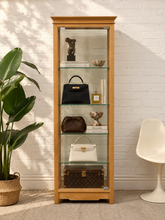 Load image into Gallery viewer, Tall light wood curio cabinet with glass door, three glass shelves, and classic stepped crown molding.