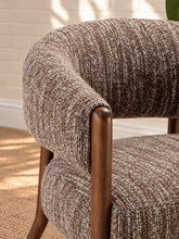 Load image into Gallery viewer, Abby mocha textured bouclé accent chair with curved wraparound backrest, cushioned seat and exposed brown solid wood legs.