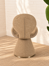 Load image into Gallery viewer, Adler fully upholstered sand dining chair with rounded back, curved wraparound seat, pedestal base, and brushed brass accent.