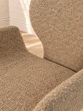 Load image into Gallery viewer, Adler fully upholstered sand dining chair with rounded back, curved wraparound seat, pedestal base, and brushed brass accent.