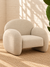 Load image into Gallery viewer, Adriana ivory chenille accent chair with rounded wraparound back, curved upholstered arms, plush seat cushion, and sculptural silhouette.