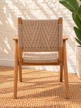 Load image into Gallery viewer, Alma natural teak wood dining armchair with tall synthetic rope woven back, woven seat, and curved wooden armrests.