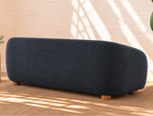 Load image into Gallery viewer, Amara slate navy curved sofa with textured upholstery, rounded arms, ball accent pillows, and wood bun feet