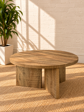 Load image into Gallery viewer, Image 4 of 5: Arni 35.5-inch round wood coffee table in Weathered Natural with sculptural three-panel base and wood-grain finish
