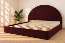 Load image into Gallery viewer, Astrid King-size bed in Burgundy performance velvet with sculptural arched headboard and streamlined plinth base.