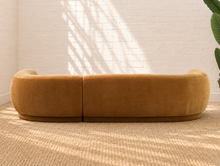 Load image into Gallery viewer, Audrey two-piece curved sectional sofa upholstered in mustard chenille with rounded arms and a sculptural wraparound back.