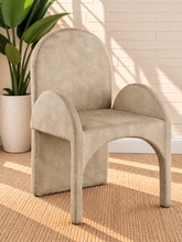 Load image into Gallery viewer, Bailey upholstered dining chair in Champagne Sand velvet with curved arms and sculptural contemporary frame