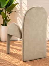 Load image into Gallery viewer, Bailey upholstered dining chair in Champagne Sand velvet with curved arms and sculptural contemporary frame
