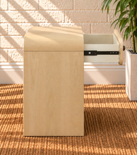 Load image into Gallery viewer, Byron Blonde Oak wood nightstand with curved frame, drawer, matte black metal handle, and open lower shelf.