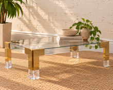 Load image into Gallery viewer, Cindy rectangular coffee table with clear glass top, polished gold stainless steel frame, and transparent acrylic legs.