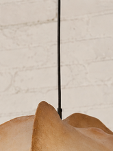 Load image into Gallery viewer, Claire hanging lamp in warm camel resin with an organic sculptural shade, overlapping curved forms, textured surface, and dark cord suspension.