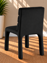 Load image into Gallery viewer, Conrad upholstered dining chair in Midnight Black velvet with deep channel-tufted back and sculptural upholstered frame