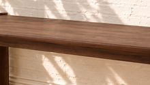 Load image into Gallery viewer, Darius rectangular dining table in natural brown Mindi wood veneer with wide panel legs and visible wood grain.