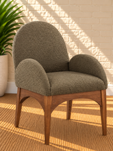 Load image into Gallery viewer, Davila Walnut dining armchair upholstered in Weathered Olive bouclé with curved arms and sculptural wood frame
