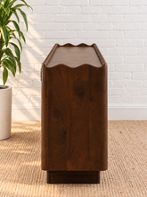 Load image into Gallery viewer, Eden natural brown mango wood credenza with sculptural wave-edged detailing, paneled cabinet doors, concealed shelving, and recessed plinth base.