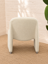 Load image into Gallery viewer, Etta white upholstered accent chair with rounded back, curved seat, sculptural side panels and silver-tone feet.
