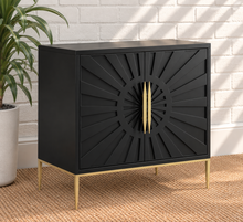 Load image into Gallery viewer, Eva midnight bar cabinet with dimensional sunburst doors, long gold handles, gold metal base, and tapered legs