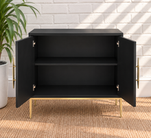 Load image into Gallery viewer, Eva midnight bar cabinet with dimensional sunburst doors, long gold handles, gold metal base, and tapered legs