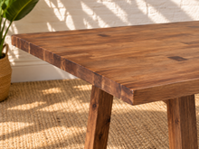 Load image into Gallery viewer, Felipe rectangular solid acacia dining table in natural brown with angled trestle legs, center stretcher and visible wood grain.