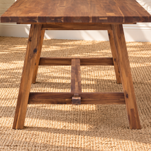 Load image into Gallery viewer, Felipe rectangular solid acacia dining table in natural brown with angled trestle legs, center stretcher and visible wood grain.