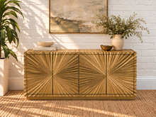 Load image into Gallery viewer, Gloria 4-Door Buffet Credenza in Radiant Gold with intricate hand-carved starburst doors and sculptural ridged detailing