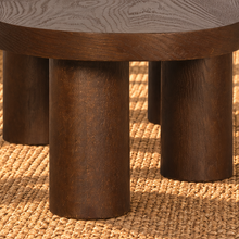 Load image into Gallery viewer, Henry solid oak coffee table in Natural Brown with organic rounded tabletop, four cylindrical legs, and prominent natural wood grain.