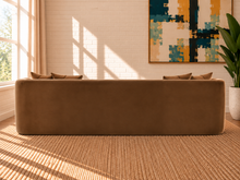 Load image into Gallery viewer, Isabelle sofa in Caramel 460 GSM velvet with curved arms, rounded base, plush seat, and coordinating throw pillows.