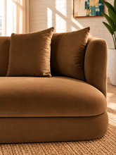 Load image into Gallery viewer, Isabelle sofa in Caramel 460 GSM velvet with curved arms, rounded base, plush seat, and coordinating throw pillows.