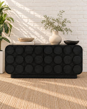 Load image into Gallery viewer, Jaylen charcoal mindi wood credenza with four cabinet doors, raised circular geometric details, rounded corners, and interior shelving.