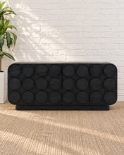 Load image into Gallery viewer, Jaylen charcoal mindi wood credenza with four cabinet doors, raised circular geometric details, rounded corners, and interior shelving.