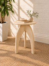 Load image into Gallery viewer, Jillian side table in sand-finished mango wood with an elongated oval tabletop, rounded edges, and sculptural tapered pedestal base.