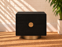 Load image into Gallery viewer, Jimena charcoal two-drawer nightstand with oak veneer, brushed brass circular handle, and rounded brass metal base.