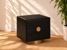 Load image into Gallery viewer, Jimena charcoal two-drawer nightstand with oak veneer, brushed brass circular handle, and rounded brass metal base.