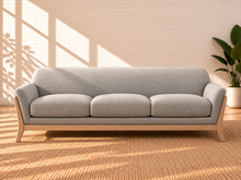 Load image into Gallery viewer, Image 1 of 5: Jules upholstered wooden sofa in Soft Ash with gray fabric, flared arms, contoured backrest, and solid Rubberwood frame