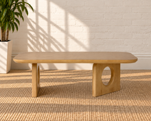 Load image into Gallery viewer, Kamari natural oak rectangular coffee table with rounded corners and two sculptural panel legs featuring circular cutouts.