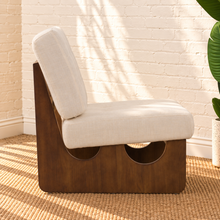 Load image into Gallery viewer, Karyl Ivory armless accent chair with ivory tufted upholstery, removable cushions and sculptural walnut-finished oak wood frame.