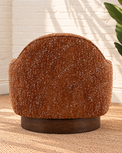 Load image into Gallery viewer, Katiana rust chunky bouclé swivel accent chair with rounded back, curved arms, cushioned seat, and dark rubber wood base.