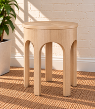 Load image into Gallery viewer, Kaylee sculptural side table in blonde oak with rounded top and arched openwork base.