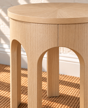 Load image into Gallery viewer, Kaylee sculptural side table in blonde oak with rounded top and arched openwork base.
