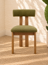 Load image into Gallery viewer, Kiki dining chair with avocado green bouclé upholstered seat and backrest, high-density foam cushioning and natural solid ash wood frame.