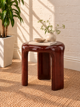 Load image into Gallery viewer, Image 2 of 5: Klarisse sculptural side table in chestnut high-gloss concrete with a rounded top and three curved integrated legs.