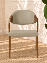 Load image into Gallery viewer, Kori warm greige leatherette dining chair with curved upholstered back and walnut-finished solid ash wood frame.