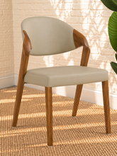 Load image into Gallery viewer, Kori warm greige leatherette dining chair with curved upholstered back and walnut-finished solid ash wood frame.