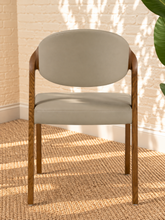 Load image into Gallery viewer, Kori warm greige leatherette dining chair with curved upholstered back and walnut-finished solid ash wood frame.