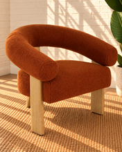Load image into Gallery viewer, Kourtney burnt orange textured accent chair with curved flared arms, cushioned seat and natural wood legs.